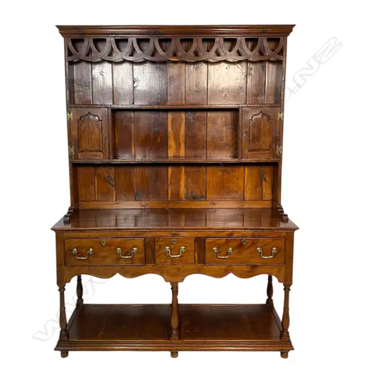 A quality George III style solid yew wood decorative plate rack back dresser - the back with over-looping frieze above two shelves and two small cupboards. The base with three frieze drawers and turned supports above the panelled lower shelf base. Traditionally made with some pegged construction. Oak lined. In good polish. 1360 x 470 x 1880mm.