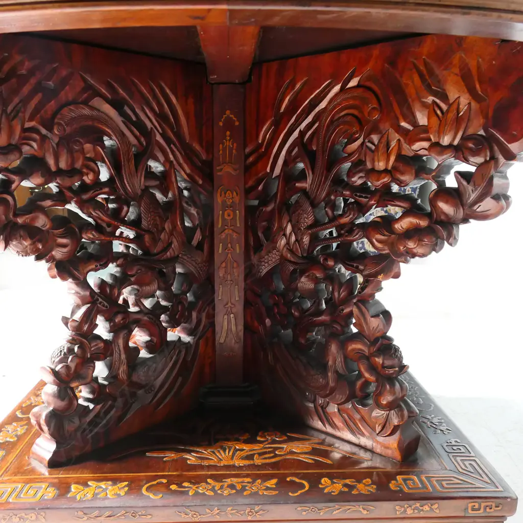 An impressive antique Chinese dining table - the round top inlaid with multiple courtyard scenes, bamboo, willow trees, clouds, phoenix birds, etc. The elaborate base with four carved substantial supports, with inlaid decoration of sacred objects on a square platform with conforming inlaid detail. 1430 x 800mm. Image 1++