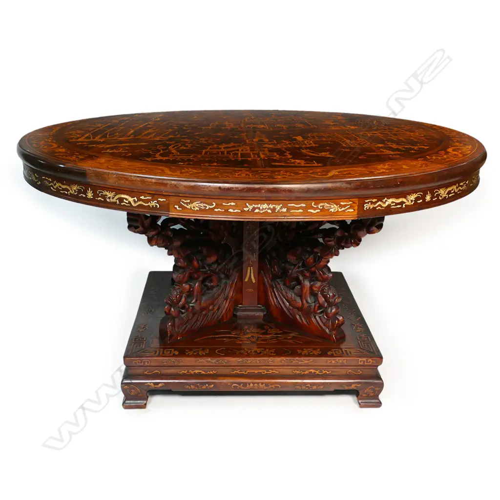 An impressive antique Chinese dining table - the round top inlaid with multiple courtyard scenes, bamboo, willow trees, clouds, phoenix birds, etc. The elaborate base with four carved substantial supports, with inlaid decoration of sacred objects on a square platform with conforming inlaid detail. 1430 x 800mm. Image 1++