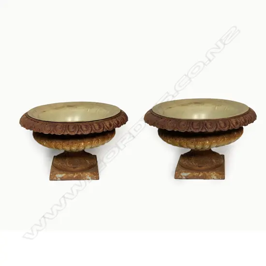 A pair of cast iron garden urns - campana shape, rusty with remains on old paint. 600 x 350mm.