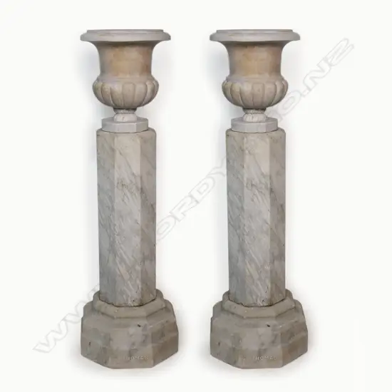 A pair of c.1900 Carrara marble tall pedestal based urns - of classical baluster form with octagonal foot on tall octagonal columns, further raised on octagonal stepped plinth base. H.1160mm,