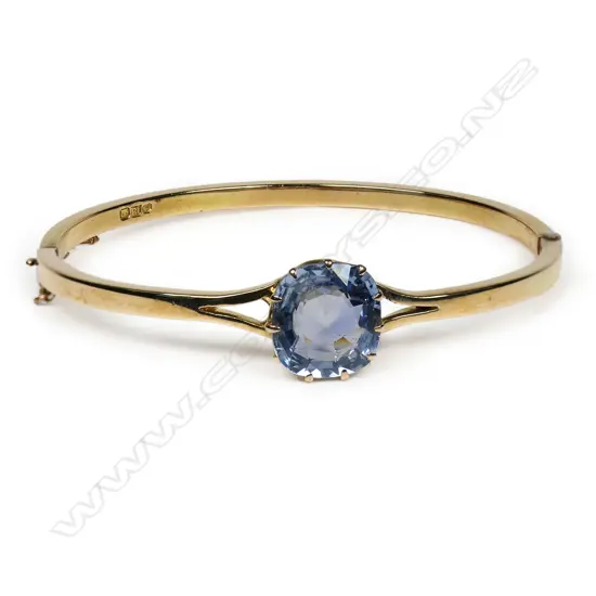 An Edwardian 18ct gold and sapphire bangle,