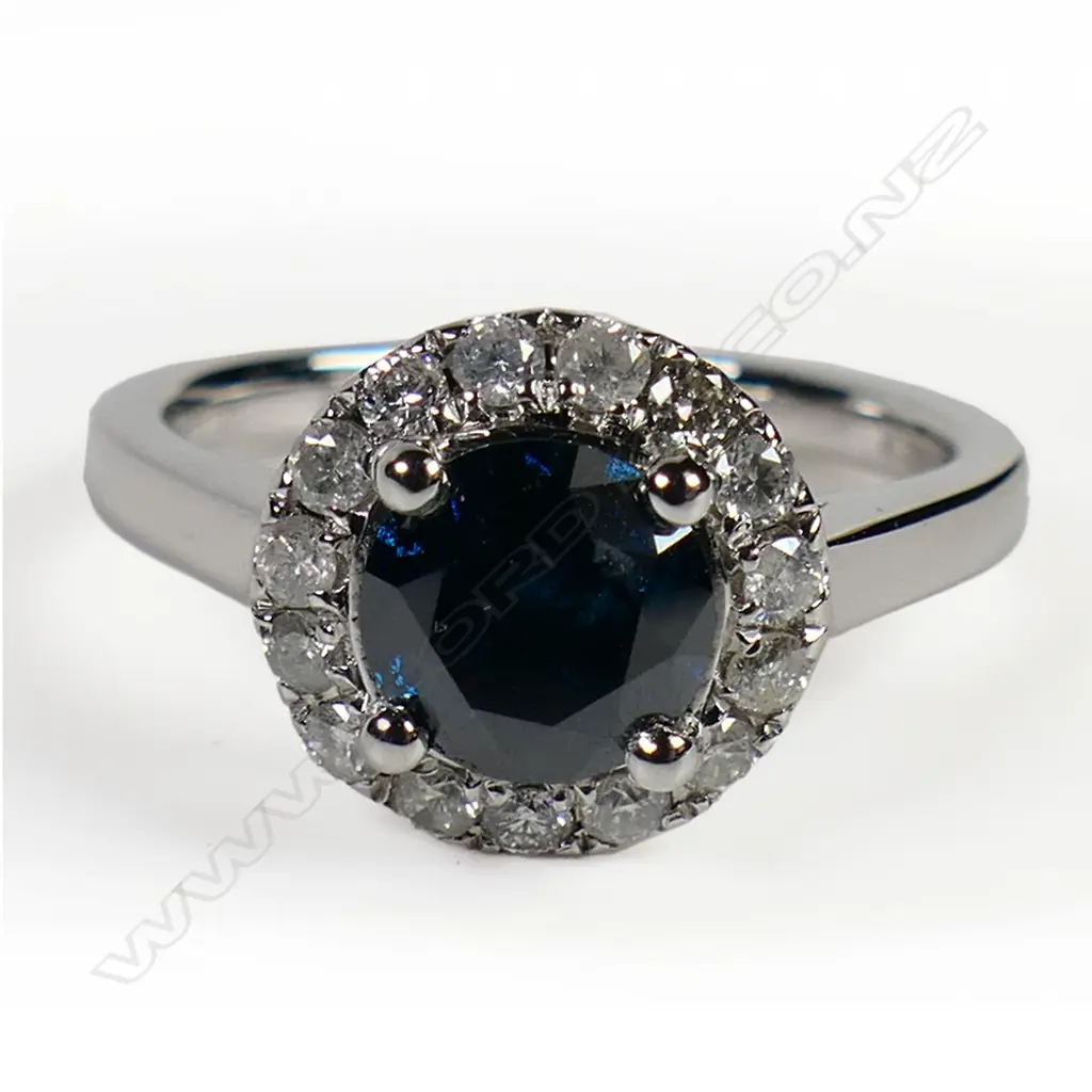 A 14ct white gold and blue diamond halo ring, Image 1++