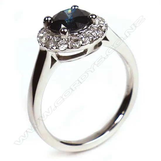 A 14ct white gold and blue diamond halo ring,