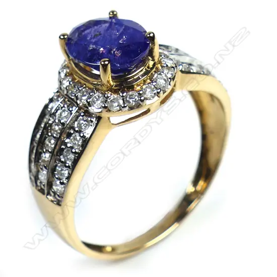 A 14ct gold tanzanite and diamond antique style halo ring,