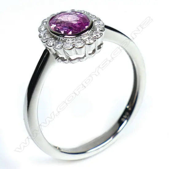 A 14ct white gold pink sapphire and diamond vintage style halo ring,