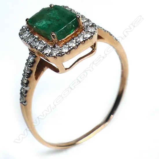 A 10ct rose gold emerald and diamond halo ring,