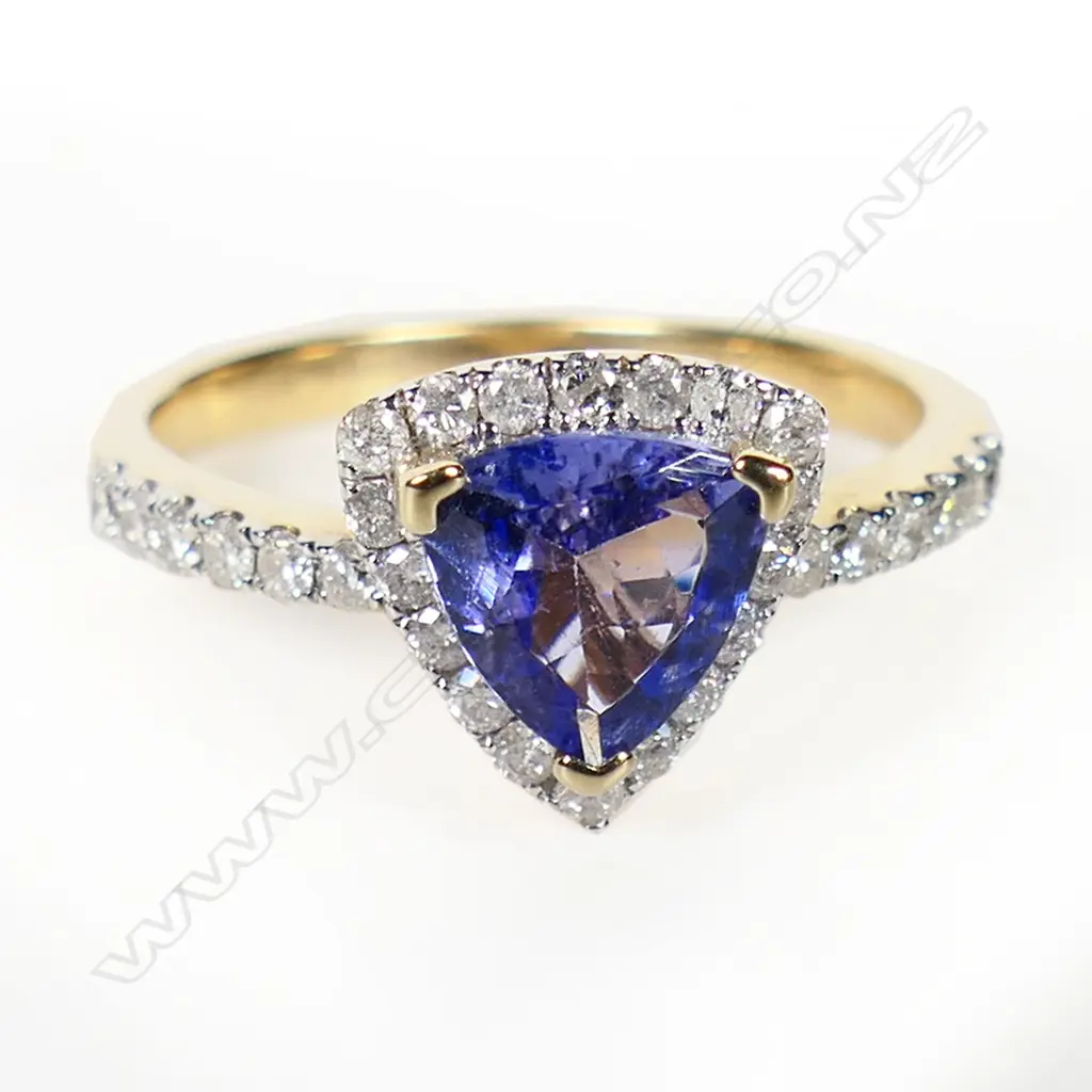 A 14ct gold tanzanite and diamond halo ring, Image 1++