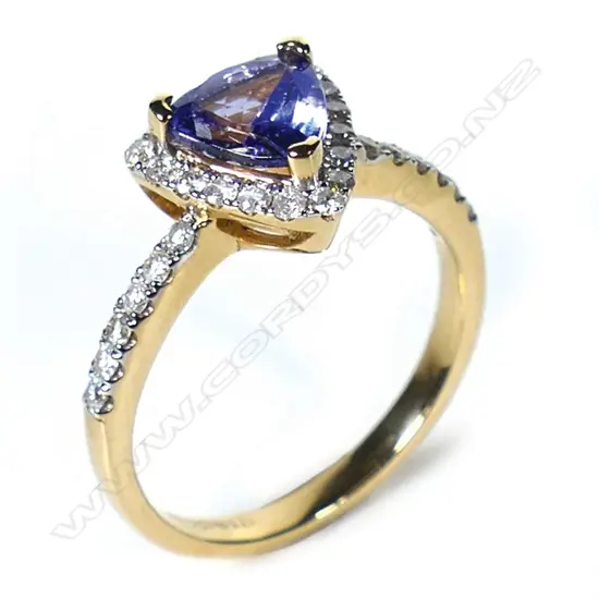 A 14ct gold tanzanite and diamond halo ring,