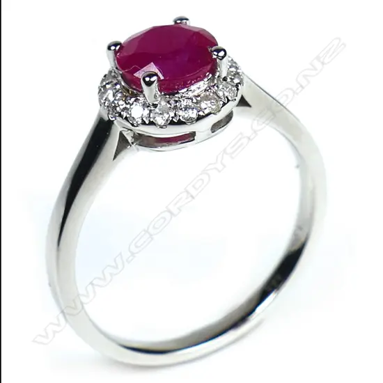 A 14ct white gold ruby and diamond halo ring,