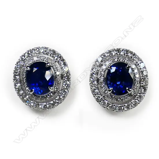 A pair of 18ct white gold sapphire and diamond double halo earrings,