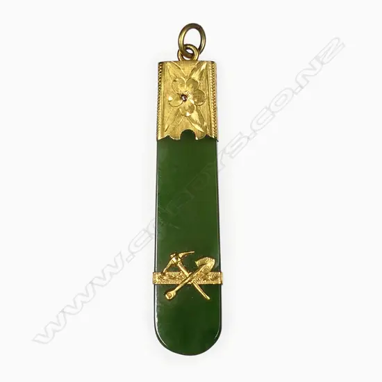 A c.1900 gilded gold and pounamu mining themed pendant,