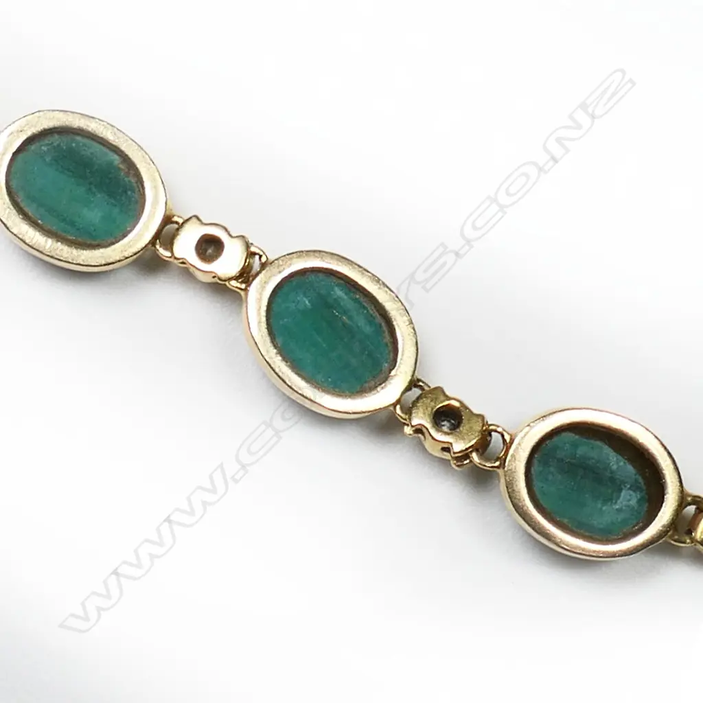 A 14ct gold malachite and diamond bracelet five oval malachite cabochons set alternatively with six small diamonds a fine articulated link chain makes up the bracelet with fold over clasp. L.200mm. Image 1++