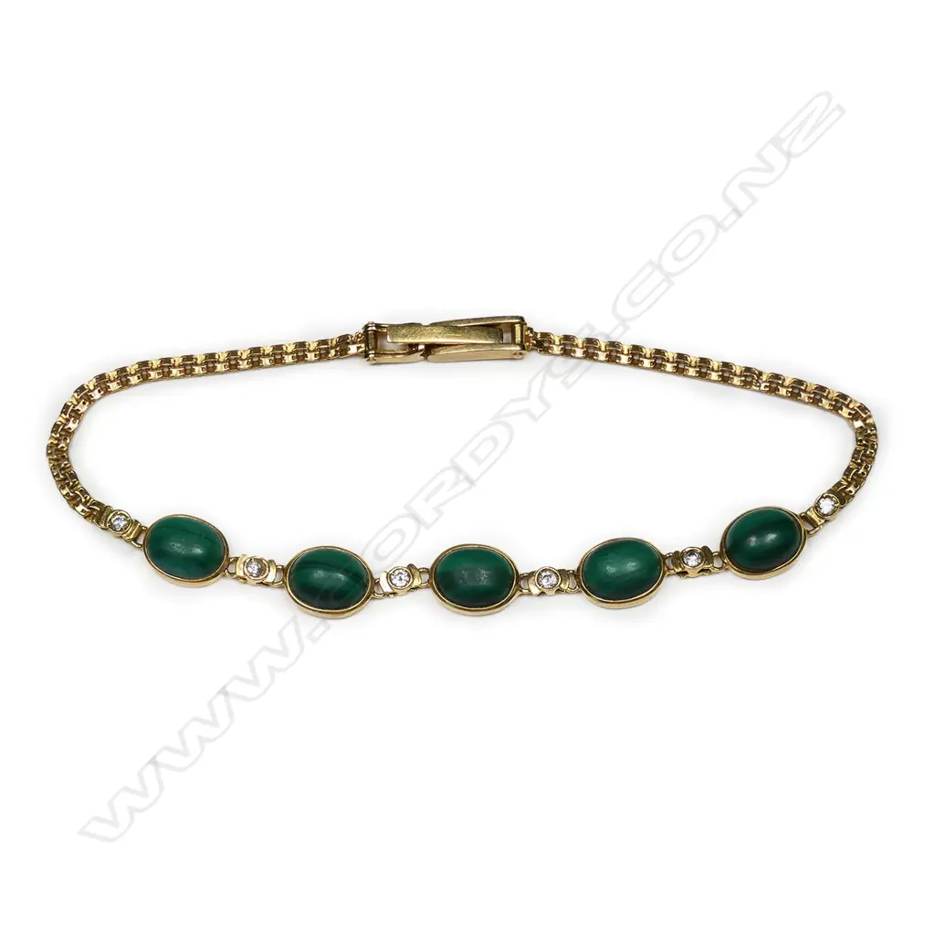 A 14ct gold malachite and diamond bracelet five oval malachite cabochons set alternatively with six small diamonds a fine articulated link chain makes up the bracelet with fold over clasp. L.200mm. Image 1++