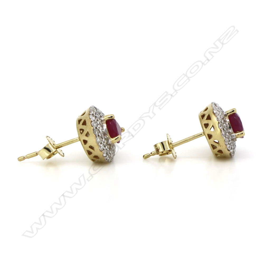 A pair of 14ct gold ruby and diamond double halo stud earrings, Image 1++