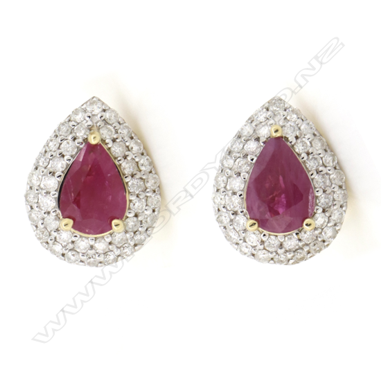 A pair of 14ct gold ruby and diamond double halo stud earrings,