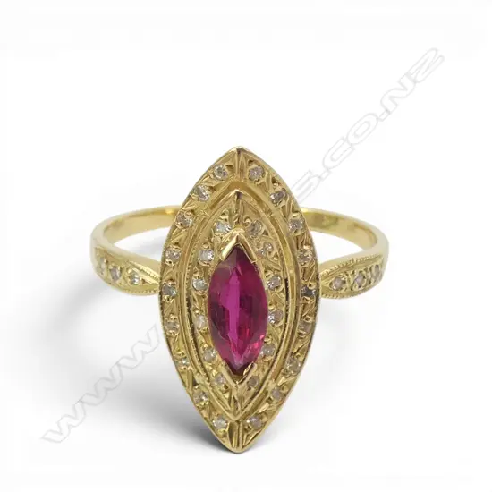 A 18ct gold ruby and diamond ring. 4gms. Size U. The marquis cut bright red ruby bar set at each end, and surrounded by two curved marquis shaped diamond set halos three single cut diamonds to each shoulder.