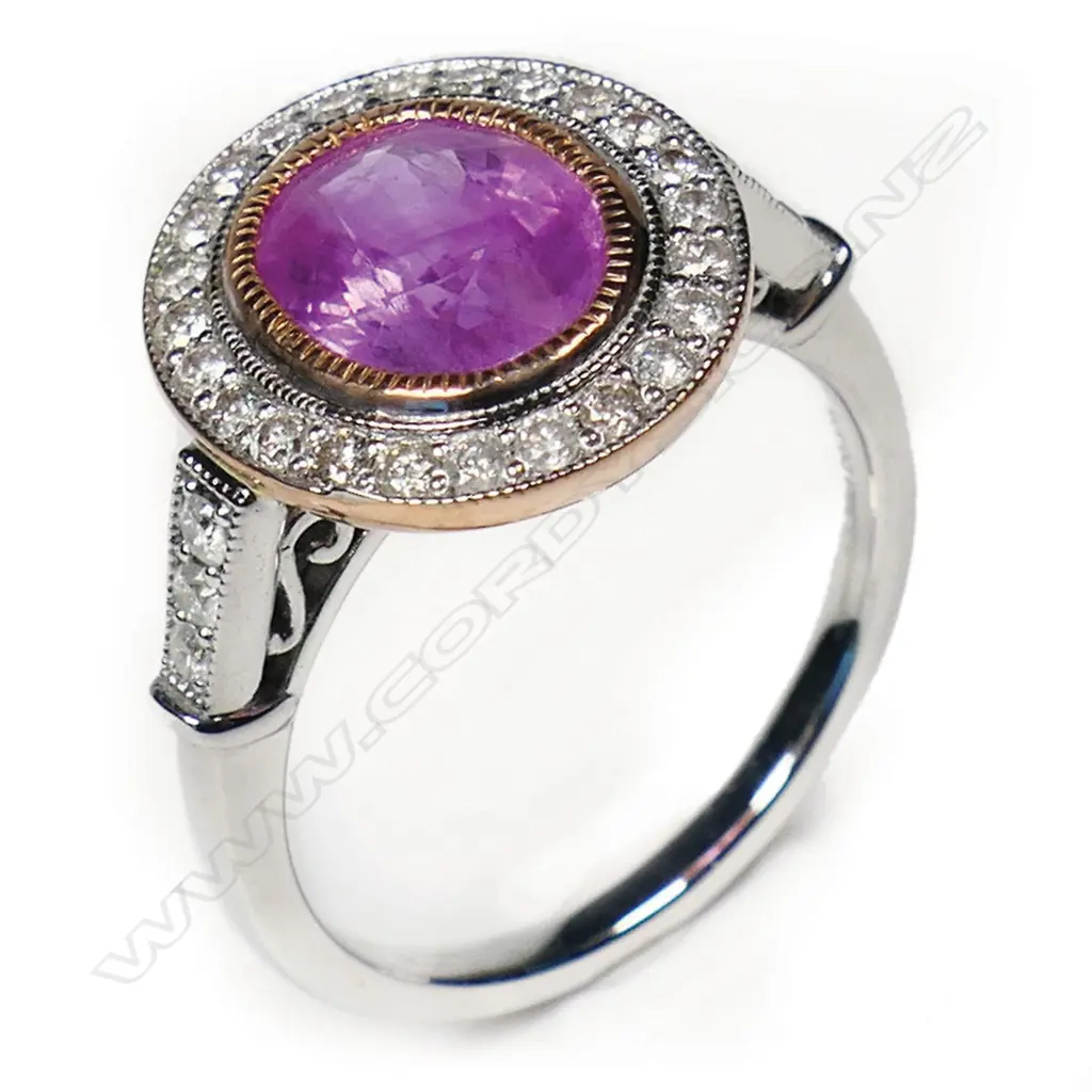 A 14ct white and rose gold pink sapphire and diamond halo ring, Image 1++