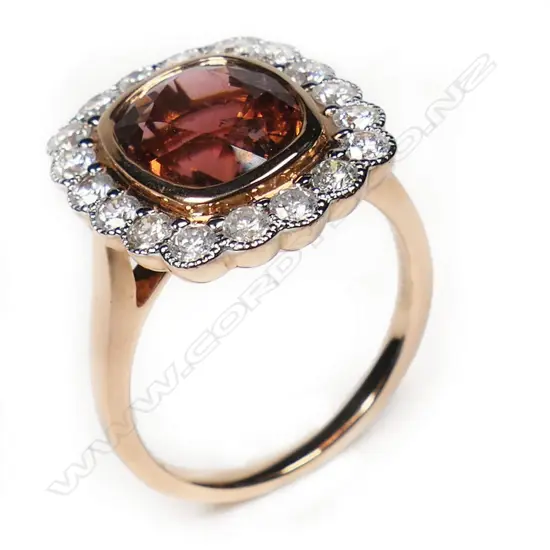 A 14ct rose and white gold pink tourmaline and diamond scalloped halo ring,