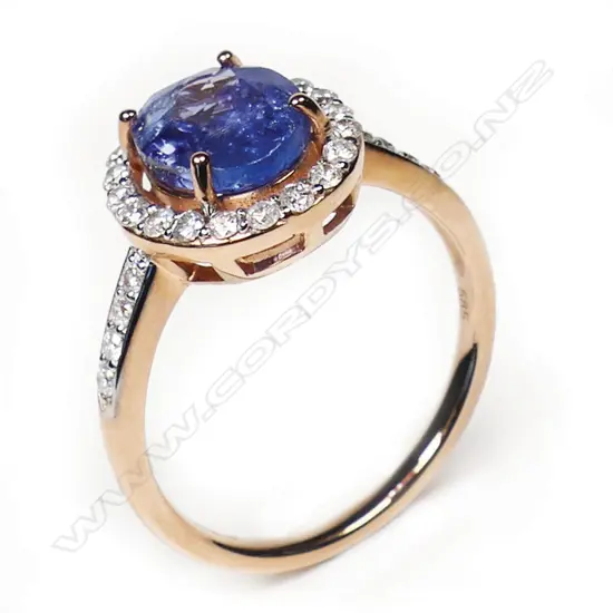 A 14ct rose gold tanzanite and diamond halo ring,