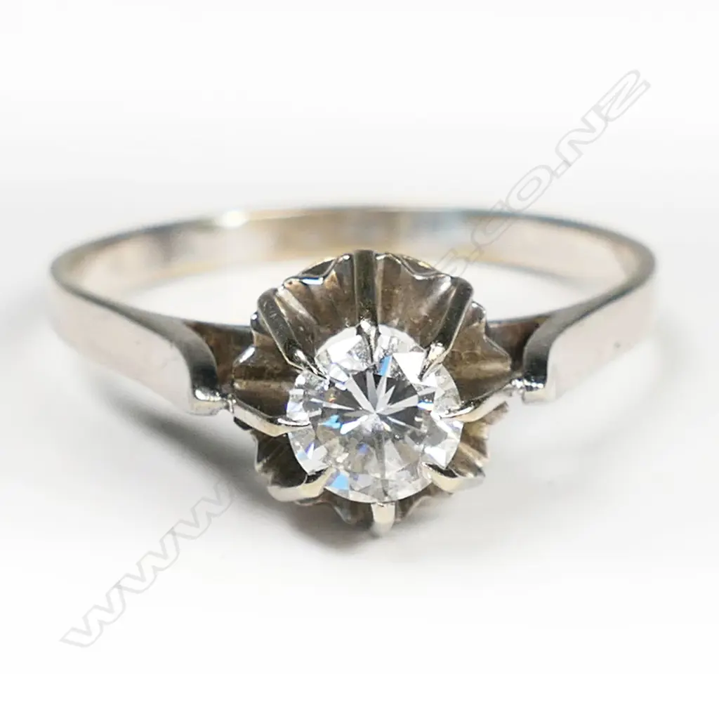 An 18ct white gold and diamond solitaire ring a round brilliant cut diamond in a high prong mount upright shoulders. Image 1++
