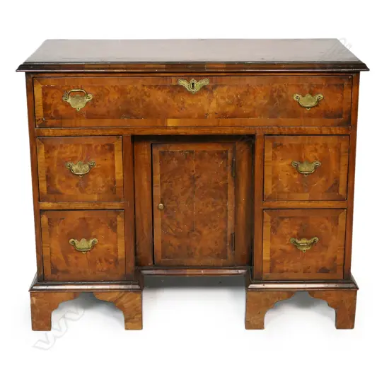 A 19thC figured walnut panelled ladies knee hole desk in the Queen Anne style,
