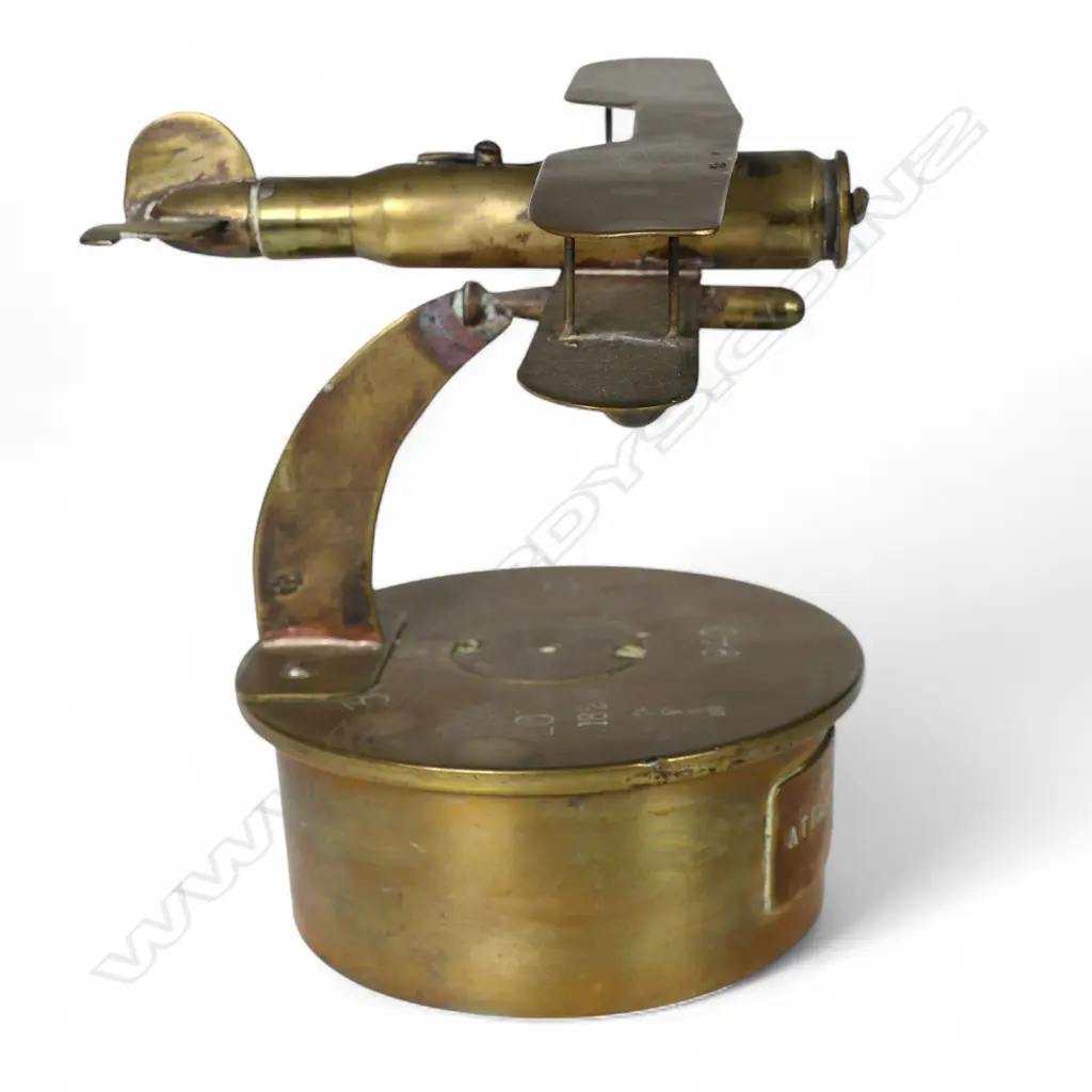 An old brass trench art bi-plane on large shell base, Image 1++