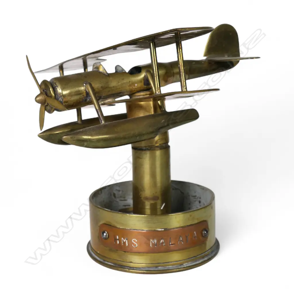 An old brass trench art float bi-plane on large shell cartridge end base, Image 1++