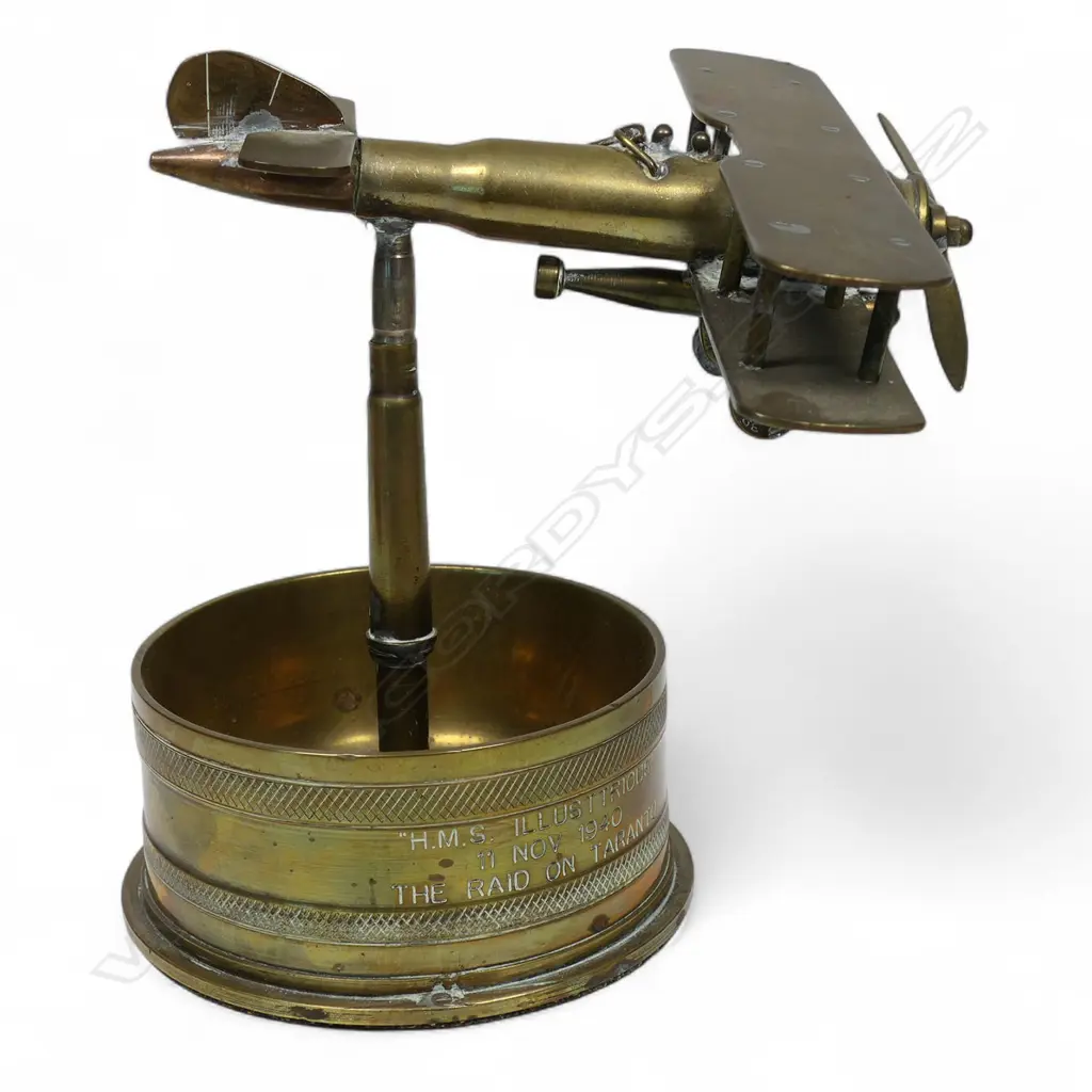 An old brass trench art float bi-plane on large shell cartridge end base, Image 1++