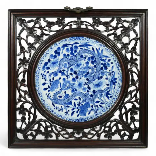 An old Oriental blue and white porcelain panel in carved & pierced wall hanging frame,