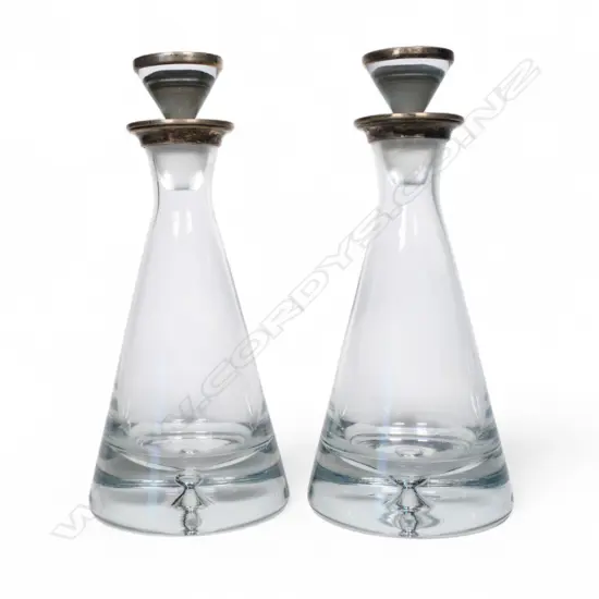 A pair of 21stC silver and glass decanters,