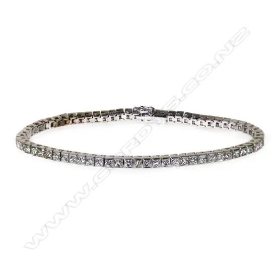 A 9ct. white gold and diamond tennis bracelet,