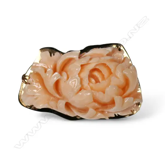 A vintage 9ct gold framed and carved coral brooch,