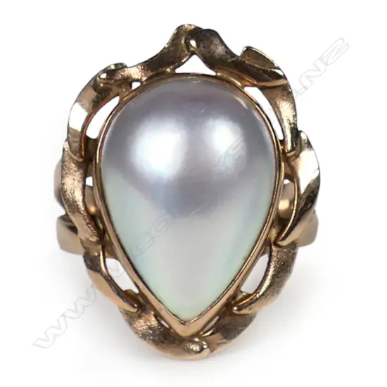 A 9ct rose gold and mabé pearl ring a pear shape mabé pearl (pink tone with green/blue nacre) bezel set with curved tapering bars comprising the frame. Ring size R. Stamped KARA. Valuation available.