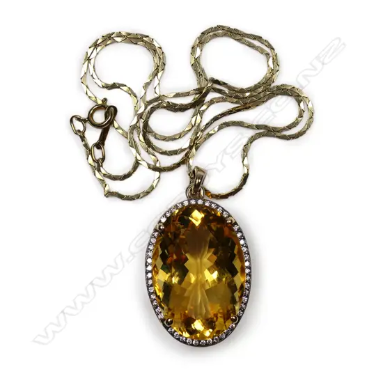 An impressive 9ct gold diamond and citrine pendant,