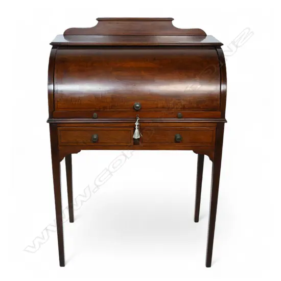 An Edwardian mahogany Sheraton revival drum front ladies desk,