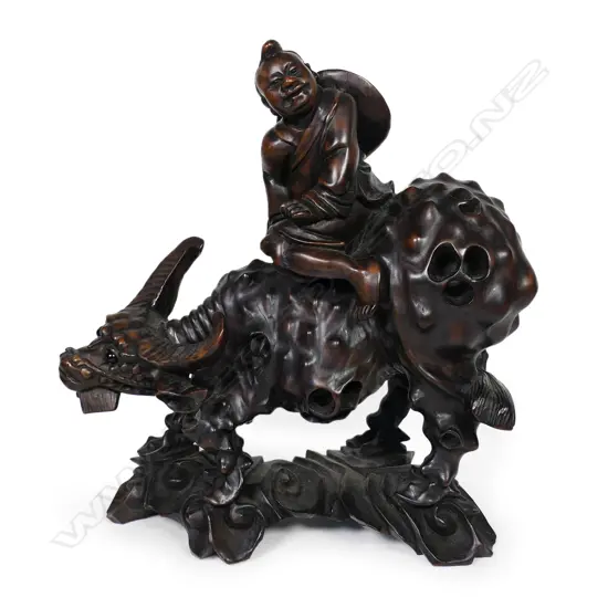 An old Chinese carved hardwood figure group of a man on an ox,