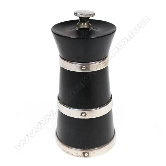 An ebony and silver banded pepper grinder,