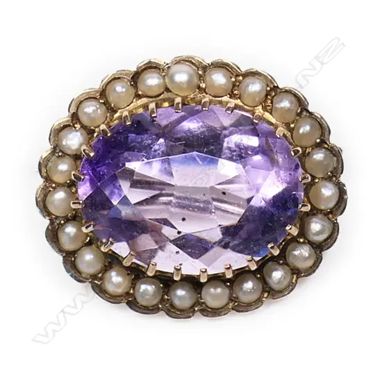 An early 19thC 'De Beer' 9ct yellow gold amethyst and seed pearl oval brooch,