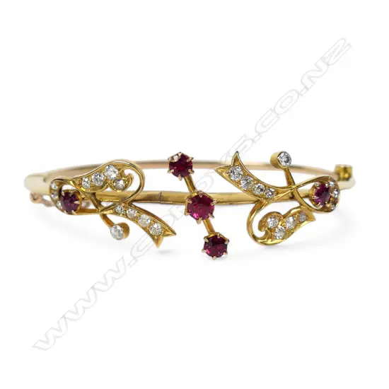 An early 1900s 18ct gold ruby and diamond snap bangle,