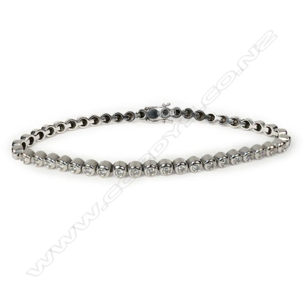 An 18ct white gold and diamond line bracelet, Image 1++