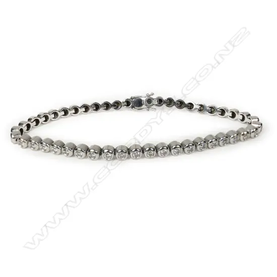 An 18ct white gold and diamond line bracelet,