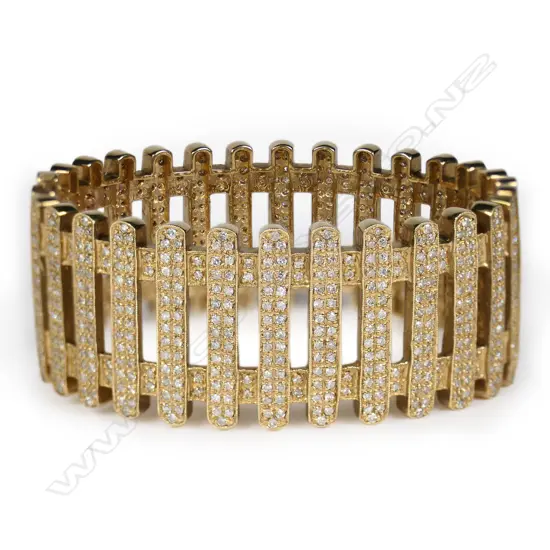 A 9ct yellow gold and multi diamond hinged bangle,