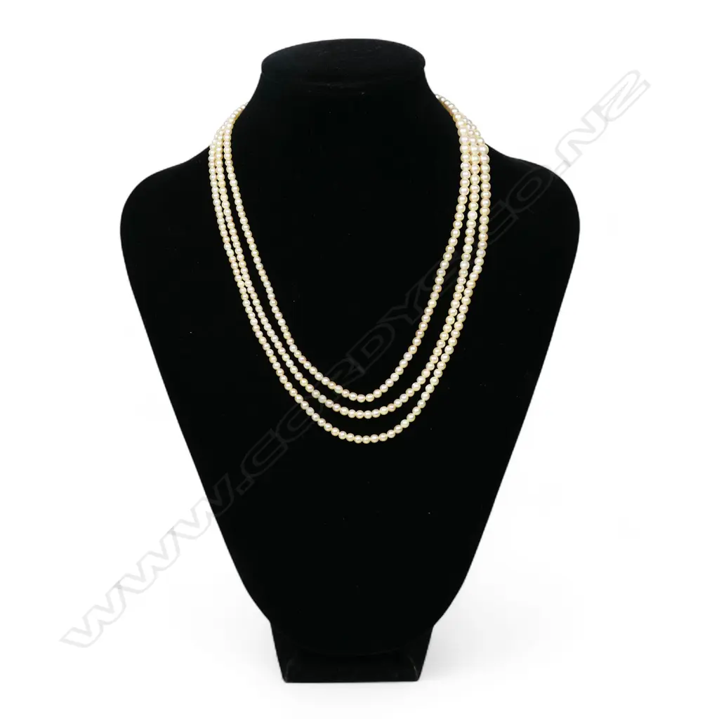 An uncommon natural pearl triple strand necklace with Art Deco platinum and diamond fancy clasp, Image 1++