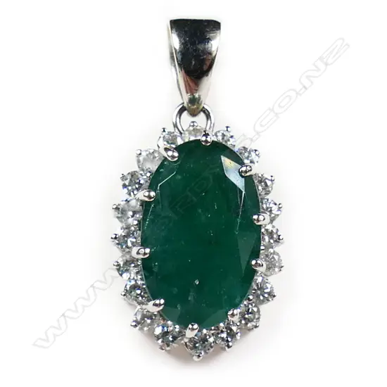 An 18ct white gold emerald and diamond pendant,