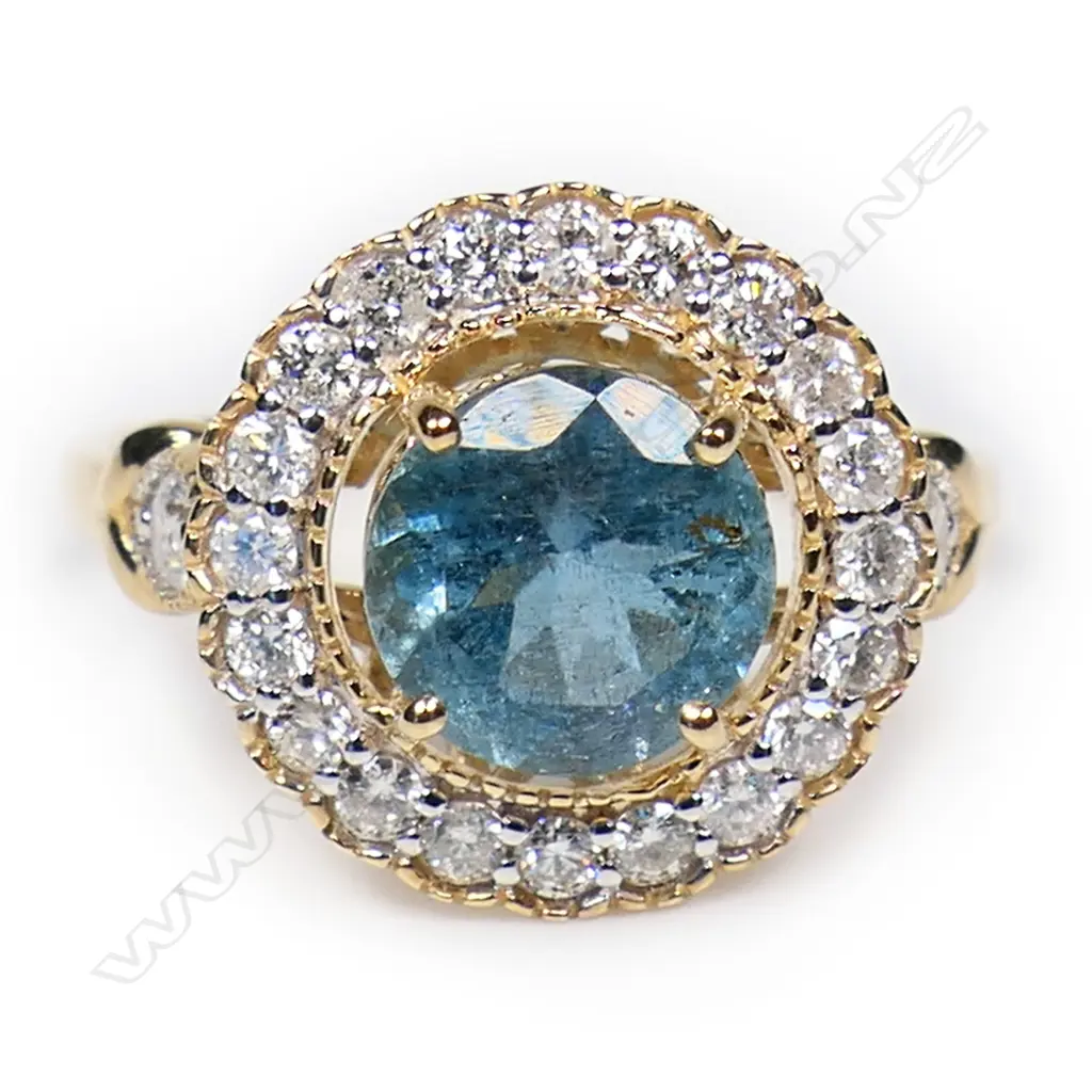 A 14ct gold aquamarine and diamond halo ring, Image 1++