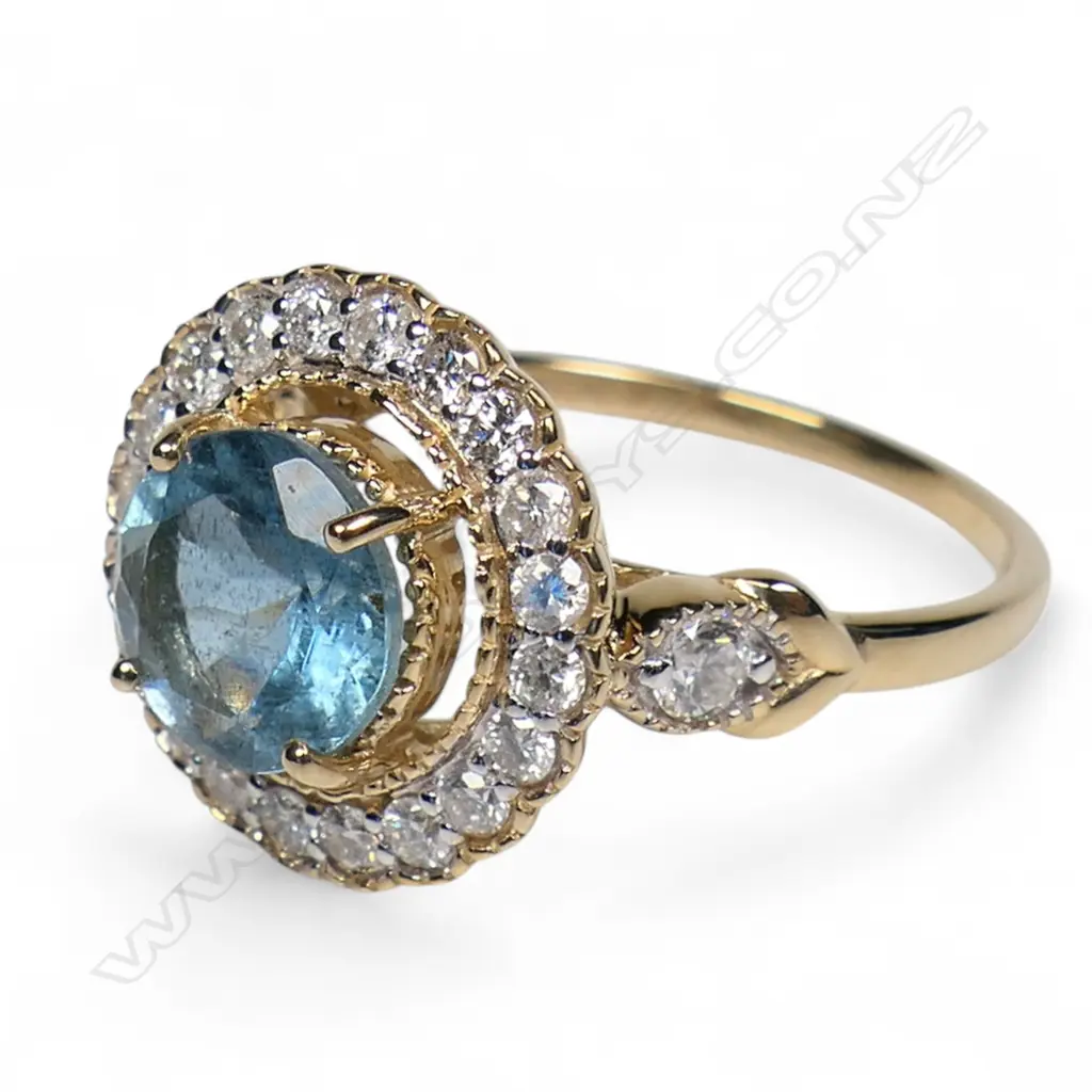 A 14ct gold aquamarine and diamond halo ring, Image 1++