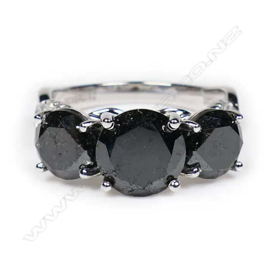 A 14ct white gold, black diamond trilogy twist band ring,