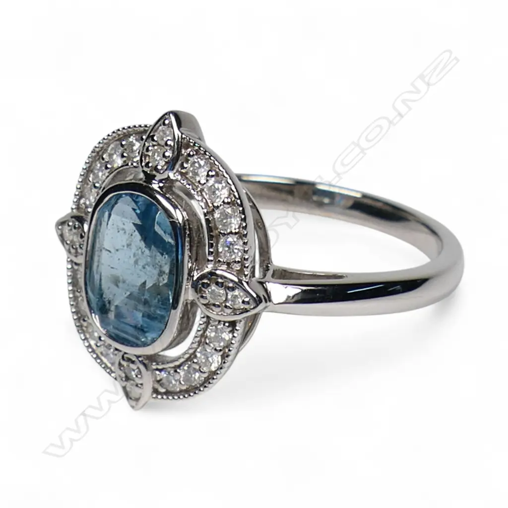 A 14ct white gold aquamarine and diamond halo ring, Image 1++