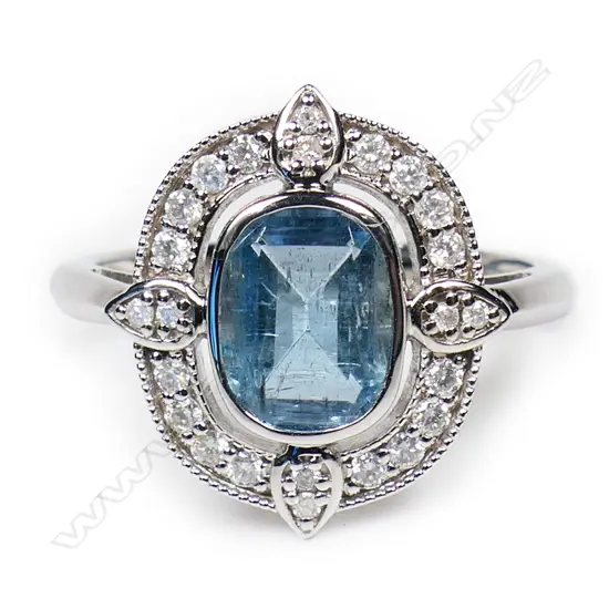 A 14ct white gold aquamarine and diamond halo ring,